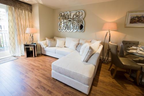 a living room with a white couch and a table at Riverside Retreat - Durham in Durham