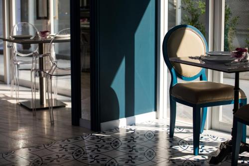 a table and a chair in front of a window at Hotel Tranz in Bangkok