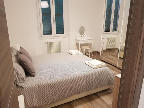 a bedroom with a bed with two towels on it at memeapartments in Genova