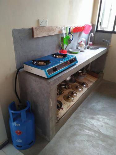 a stove in a kitchen with a counter top at Shining Line in Koggala
