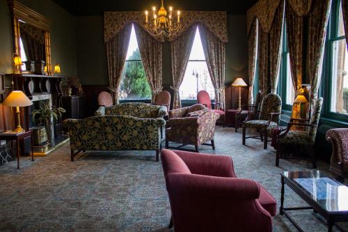 a living room filled with furniture and a chandelier at The Ballachulish Hotel in Glencoe
