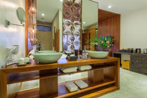 a bathroom with two sinks on a wooden counter at Golden Temple Boutique in Siem Reap
