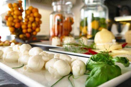 a plate of food with vegetables on a table at Palazzo De Noha - Boutique Hotel in Lecce