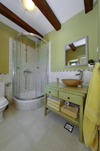 a bathroom with a sink and a shower and a tub at Olive's Hug in Poljana