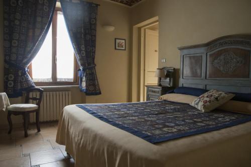 a bedroom with a large bed and a window at Il Cenerino in Venaria Reale