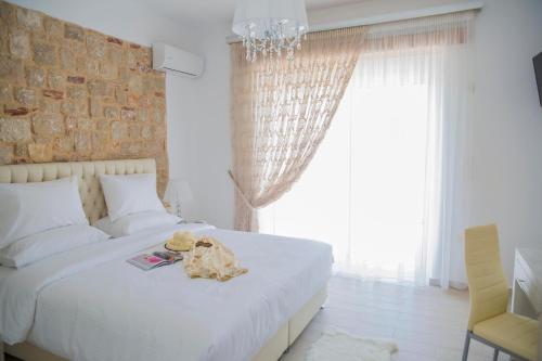 Postel nebo postele na pokoji v ubytování G&K Stone Suites