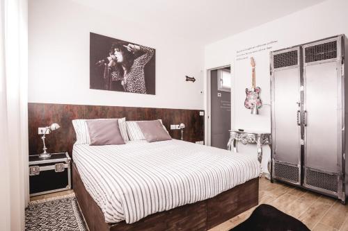 a bedroom with a large bed with a white and gray bedspread at Lullaby B&B in Treviso