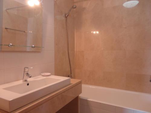a bathroom with a sink and a shower and a tub at Top Floor in City Center Funchal in Funchal