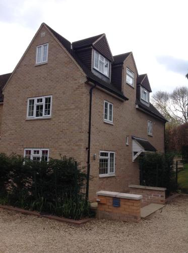 a large brick house with white windows on it at Oxford Apartments 2 in Oxford