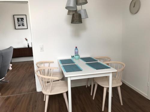 a dining room table and chairs with a blue table at Quartier 1903 in Oldenburg