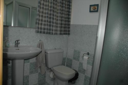 a bathroom with a toilet and a sink at 31 Memories in Pembroke