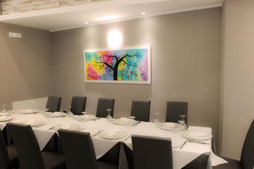 a conference room with a table and a painting on the wall at Hotel Duca Di Calabria in Serra San Bruno