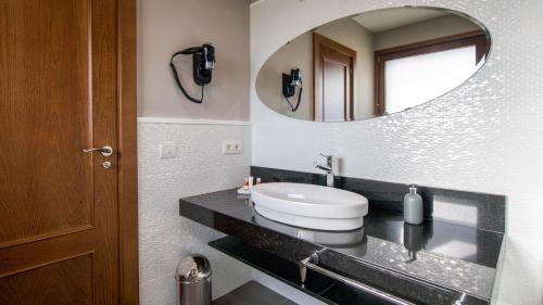 a bathroom with a sink and a mirror at LES FEIXES LLARGUES - max 18 pax in Bolvir