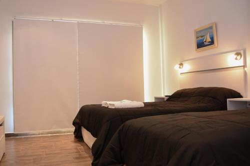 a bedroom with two beds and a large window at JAK Colón in Colón