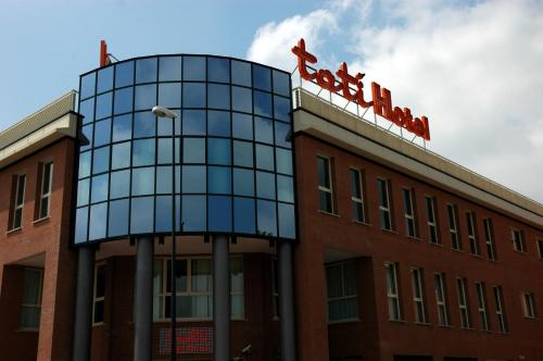 a building with a sign on top of it at Tatì Hotel in Lugo