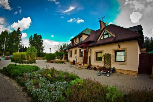 a house with a garden in front of it at Dwa Bratanki in Rzeszów