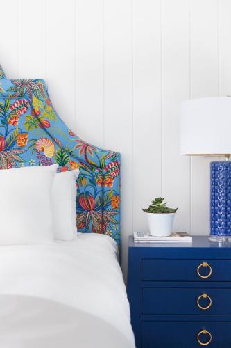 a bedroom with a bed and a blue dresser at Yachtsman Lodge & Marina in Kennebunkport