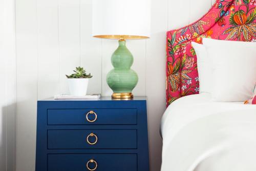 a blue dresser with a lamp on it next to a bed at Yachtsman Lodge & Marina in Kennebunkport