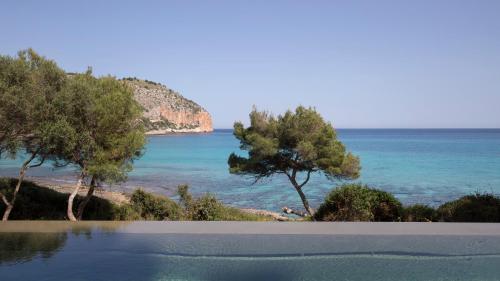 a swimming pool with a view of the ocean at Can Simoneta - Adults Only in Canyamel