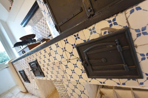 a kitchen with blue and white tiles on the wall at Masserie Maresca in Ostuni
