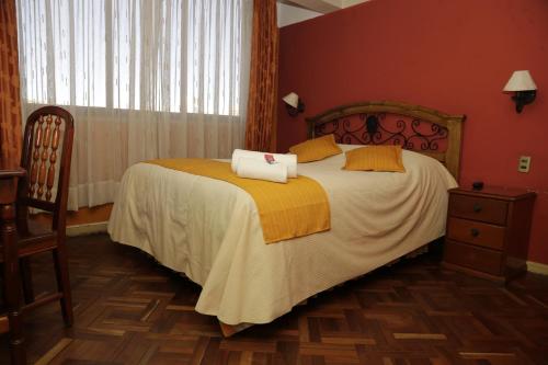 a bedroom with a bed with two towels on it at Isabela Hotel Suite in La Paz