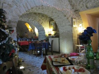 a living room with a christmas tree and a dining room at Il Fortilizio in Pietrelcina