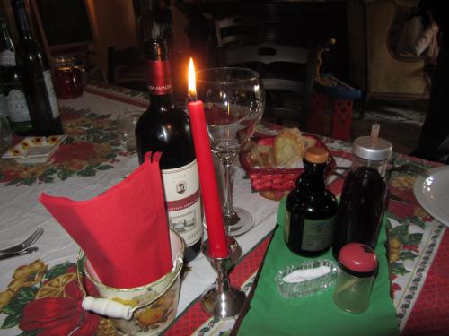 a table with two bottles of wine and a candle at Il Fortilizio in Pietrelcina