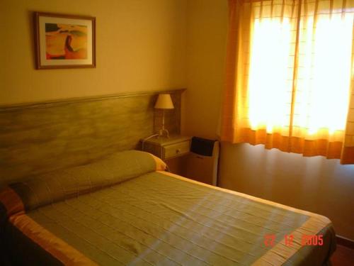 a bedroom with a bed and a window at Lahuen-co Paraje de Mar in Valeria del Mar