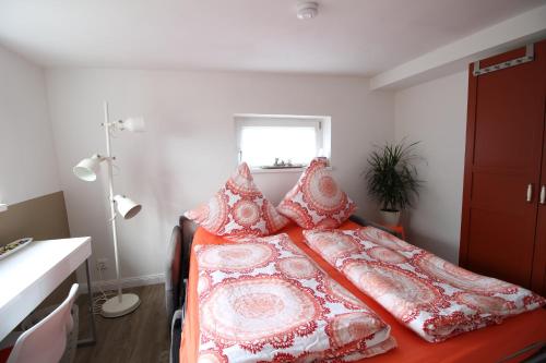 a bedroom with a bed with pillows and a window at Elbperle94 in Hamburg