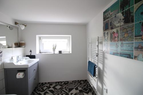 a white bathroom with a sink and a window at Elbperle94 in Hamburg