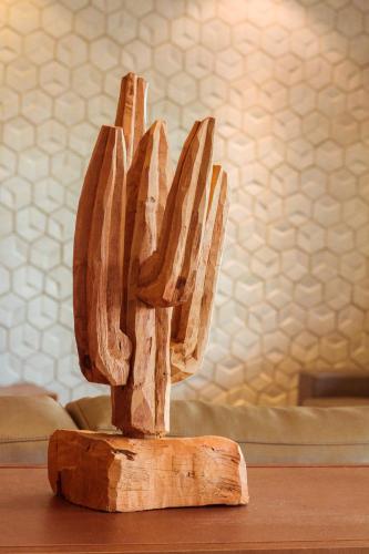 a wooden sculpture of a cactus on a table at Caruaru Park Hotel in Caruaru
