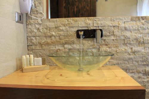 a glass sink on a counter in a bathroom at DreamWoods in Puerto Varas