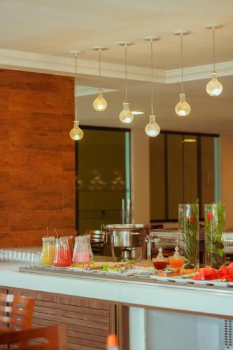 a kitchen with a counter with some food on it at Caruaru Park Hotel in Caruaru