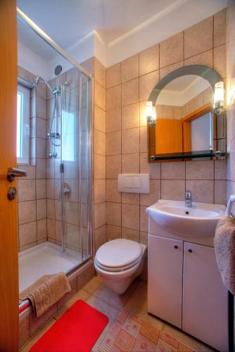 a bathroom with a toilet and a shower and a sink at Villa D&I in Srima