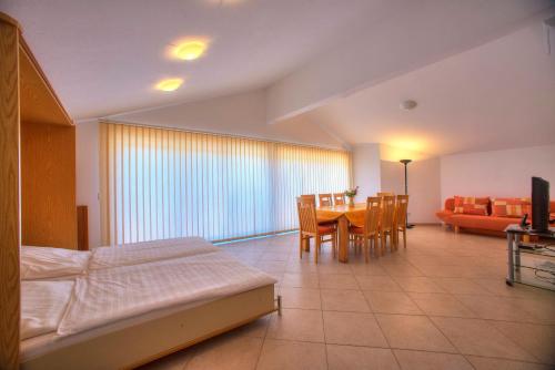 a bedroom with a bed and a table and chairs at Villa D&I in Srima