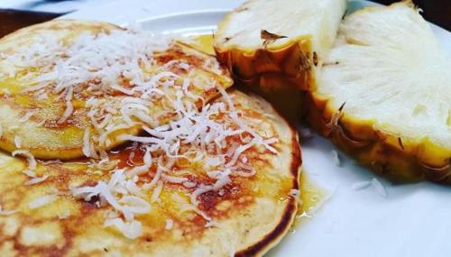 two pancakes with cheese on a white plate at Casa del Sol in Montañita