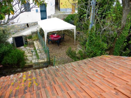 an overhead view of a patio with a white umbrella at Casa Tainin in Valloria