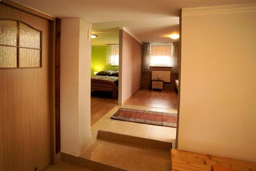 a hallway leading to a bedroom with a bed at Agroturystka Na Polanie in Święta Katarzyna