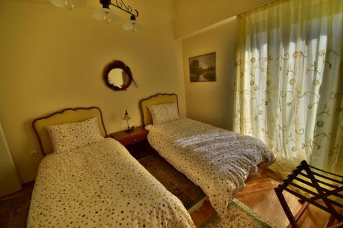 a bedroom with two beds and a window at Classy 2 bedroom apartment under Acropolis at Thisseio in Athens