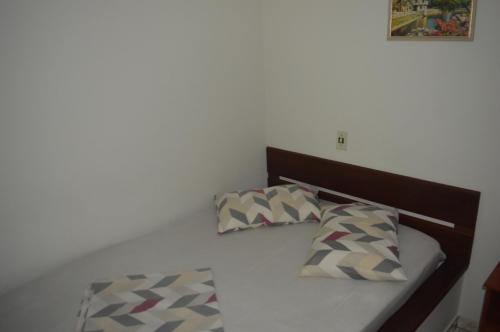 a bed with two pillows on top of it at Pousada Paraíso in Ilha do Mel