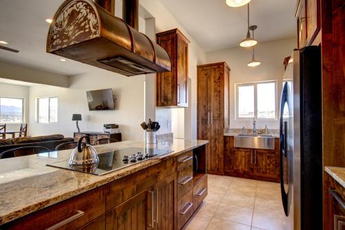 a kitchen with a sink and a refrigerator at The Lookout at Sevier River in Hatch