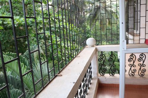 a balcony with a iron fence and a bench at Asian Golden Sands - S7 & S8 in Benaulim