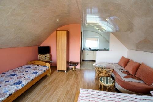 a bedroom with a bed and a couch at Agroturystka Na Polanie in Święta Katarzyna