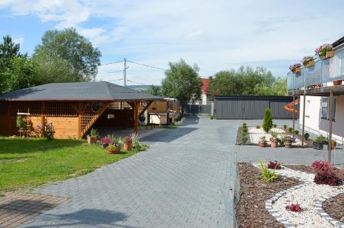 a driveway leading to a building with a gazebo at Agroturystka Na Polanie in Święta Katarzyna