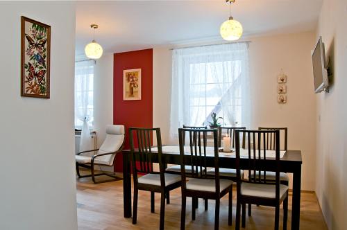 a dining room with a black table and chairs at Miodowy Zakątek in Łabowa