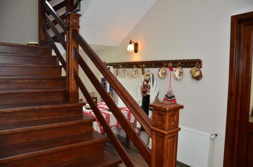 a staircase in a house with christmas ornaments on the wall at Pensiunea Valea Pinului in Rau Sadului