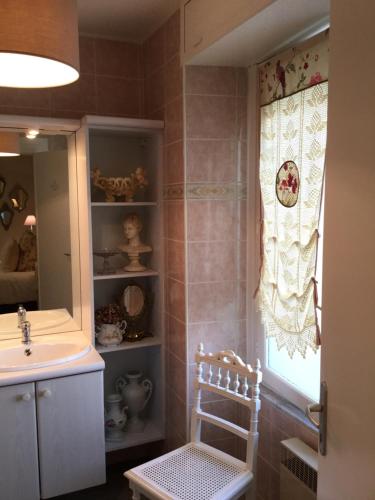 a bathroom with a sink and a mirror at L'Orangerie de Camperos in Barsac