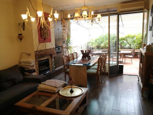 a living room with a couch and a table at Casa con vistas in Barcelona