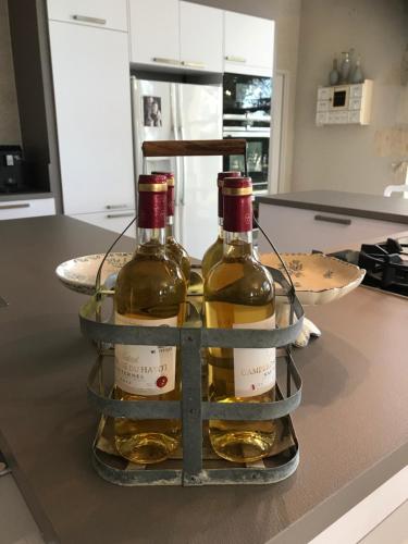 two bottles of wine sitting on top of a kitchen counter at L'Orangerie de Camperos in Barsac