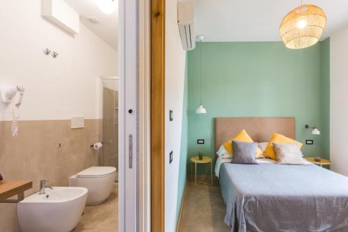 a bedroom with a bed and a bathroom with a sink at SorrentoVibes - Luxury Four Bedroom Home with Amazing Terraces in Sorrento in Sorrento